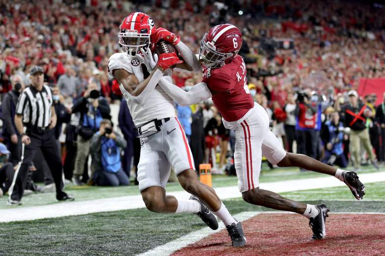 Adonai Mitchell #5 of the Georgia Bulldogs catches the ball for a touchdown against Khyree Jackson #6 of the Alabama Crimson Tide in the fourth quarter of the game during the 2022 CFP National Championship Game at Lucas Oil Stadium on January 10, 2022 in Indianapolis, Indiana.