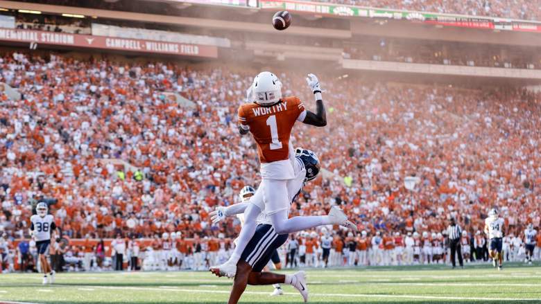 Xavier Worthy of the Texas Longhorns leaps to make a reception while defended by Eddie Heckard of the Brigham Young Cougars in the second half at Darrell K Royal-Texas Memorial Stadium on October 28, 2023.