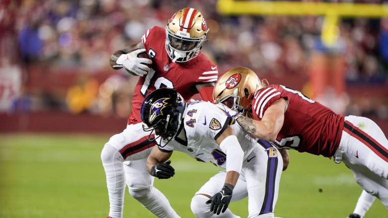 Ravens CB Marlon Humphrey tackles 49ers WR Deebo Samuel while being blocked by TE George Kittle.