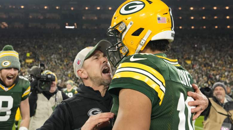Packers coach Matt LaFleur hugs Jordan Love (right) after the team earned a spot in the playoffs.