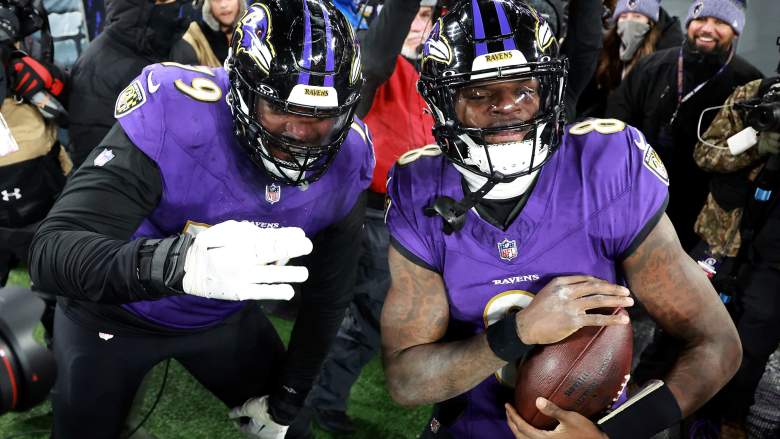 Ravens QB Lamar Jackson celebrates touchdown after running down the tunnel with teammate Ronnie Stanley.