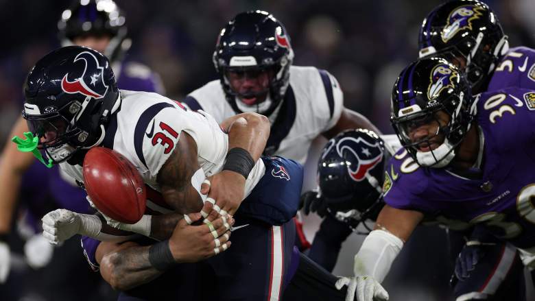 Texans RB Dameon Pierce fumbles as Ravens swarm him.