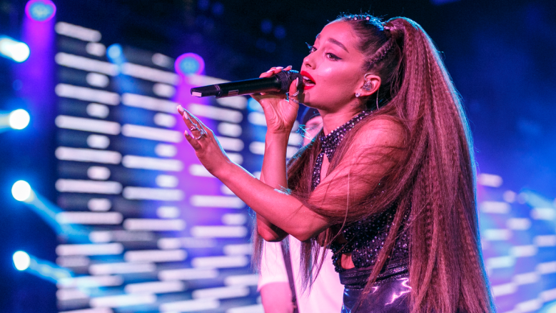 Ariana Grande performs on stage.