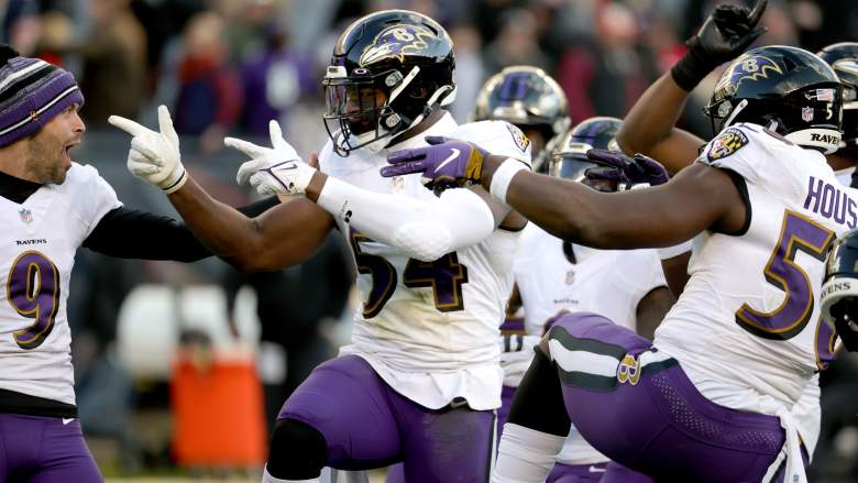 Ravens LB Tyus Bowser celebrates with teammates during 2021 game against Bears.