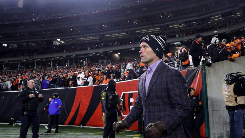GM Eric DeCosta enters the field before playoff game against Bengals.
