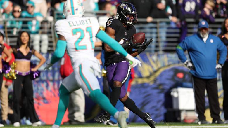 Ravens RB Justice Hill catches a touchdown pass against the Dolphins.
