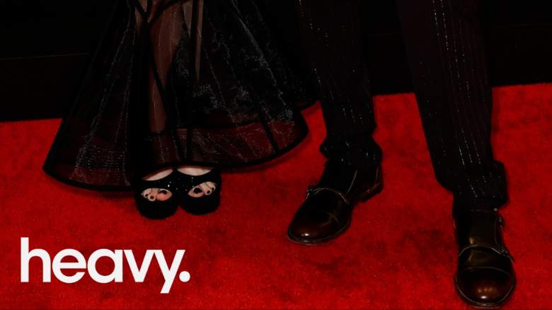 Two people standing on the red carpet.