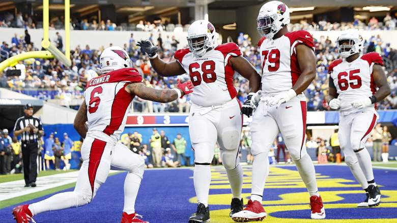 Cardinals OT Josh Jones celebrates with teammates after touchdown against Rams.