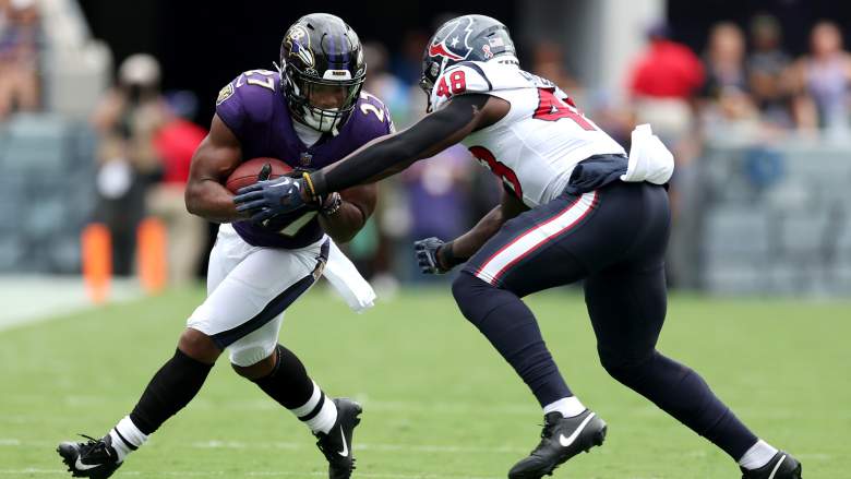 Ravens RB J.K. Dobbins fends off a tackle in Week 1 against the Texans.