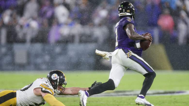 Ravens QB Tyler Huntley evades a sack by Steelers DL T.J. Watt.
