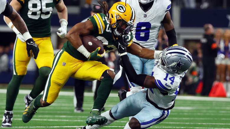 Packers RB Aaron Jones throws a stiff arm in playoff game against the Cowboys.