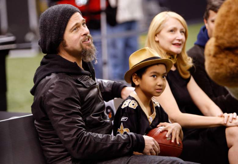 Brad Pitt sits on the sidelines at a Saints game.