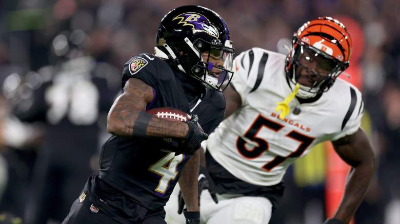 Ravens WR Zay Flowers evades tackle against division rival Bengals.