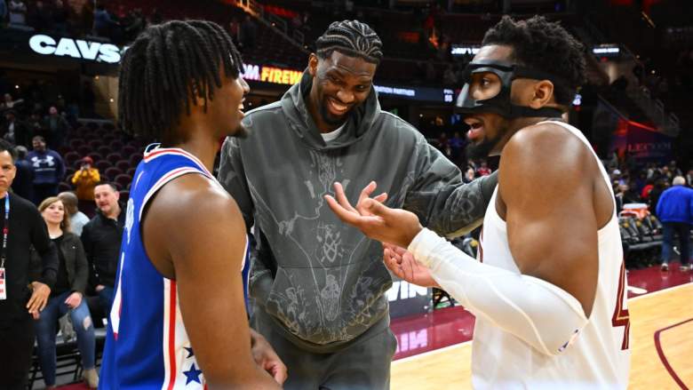Cavs' Donovan Mitchell with Sixers Joel Embiid and Tyrese Maxey