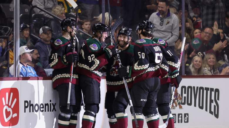 Dylan Guenther celebrates a goal with other Arizona Coyotes players