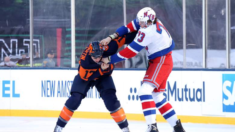 Matt Rempe #73 of the New York Rangers fights with Matt Martin #17 of the New York Islanders