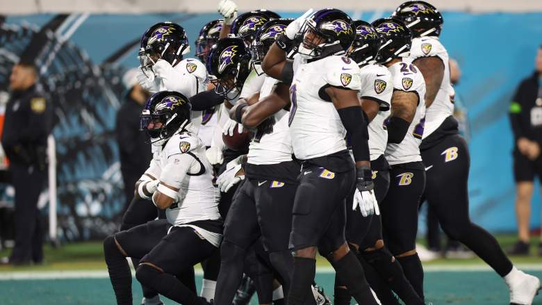 Ravens' defense celebrates turnover in game against Jaguars.