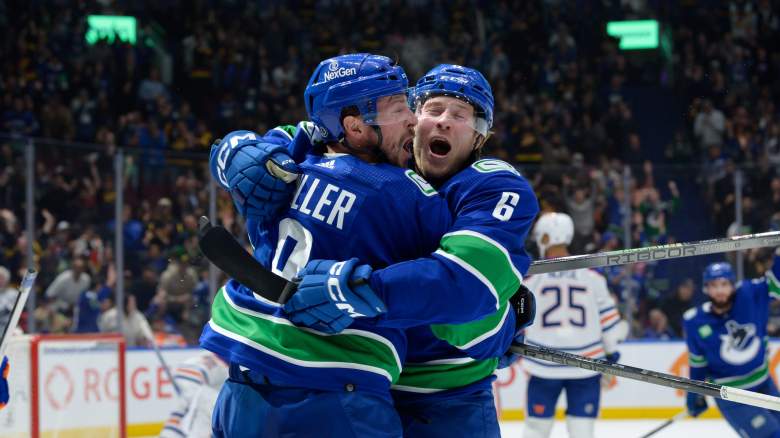 Vancouver Canucks player celebrate after scoring a goal.
