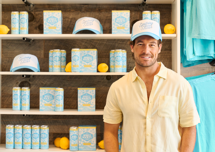 Craig Conover poses in front of cans of the new flavor of Spritz Society. 