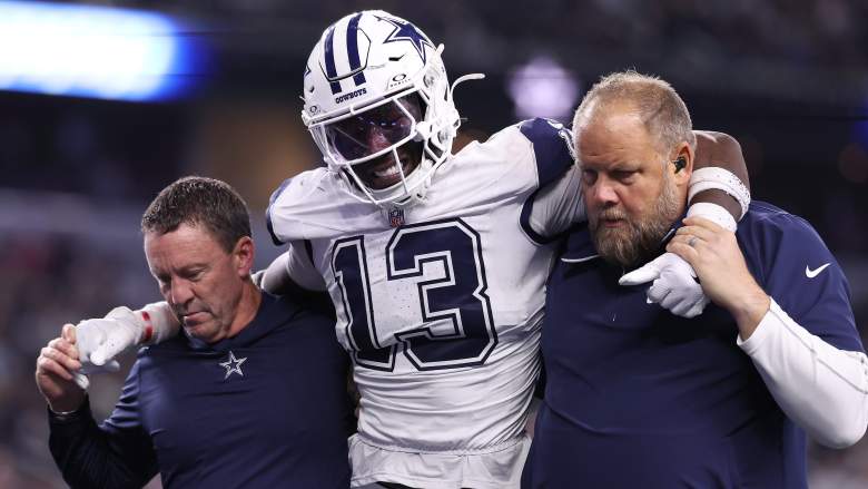 DeMarvion Overshown of the Dallas Cowboys is assisted off the field.