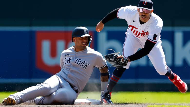 Carlos Correa (r) make a tag.