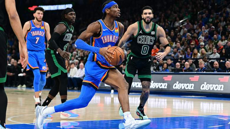 Shai Gilgeous-Alexander drives against Jayson Tatum.