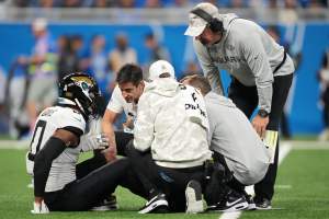 Gabe Davis sits on an NFL field injured.