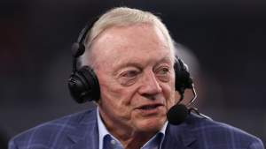 Jerry Jones participates in a NFL broadcast with a headset.