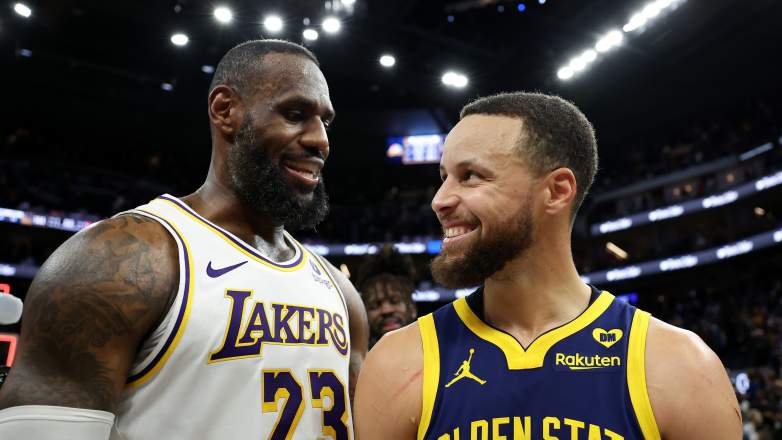 Los Angeles Lakers forward LeBron James confers with Golden State Warriors guard Stephen Curry