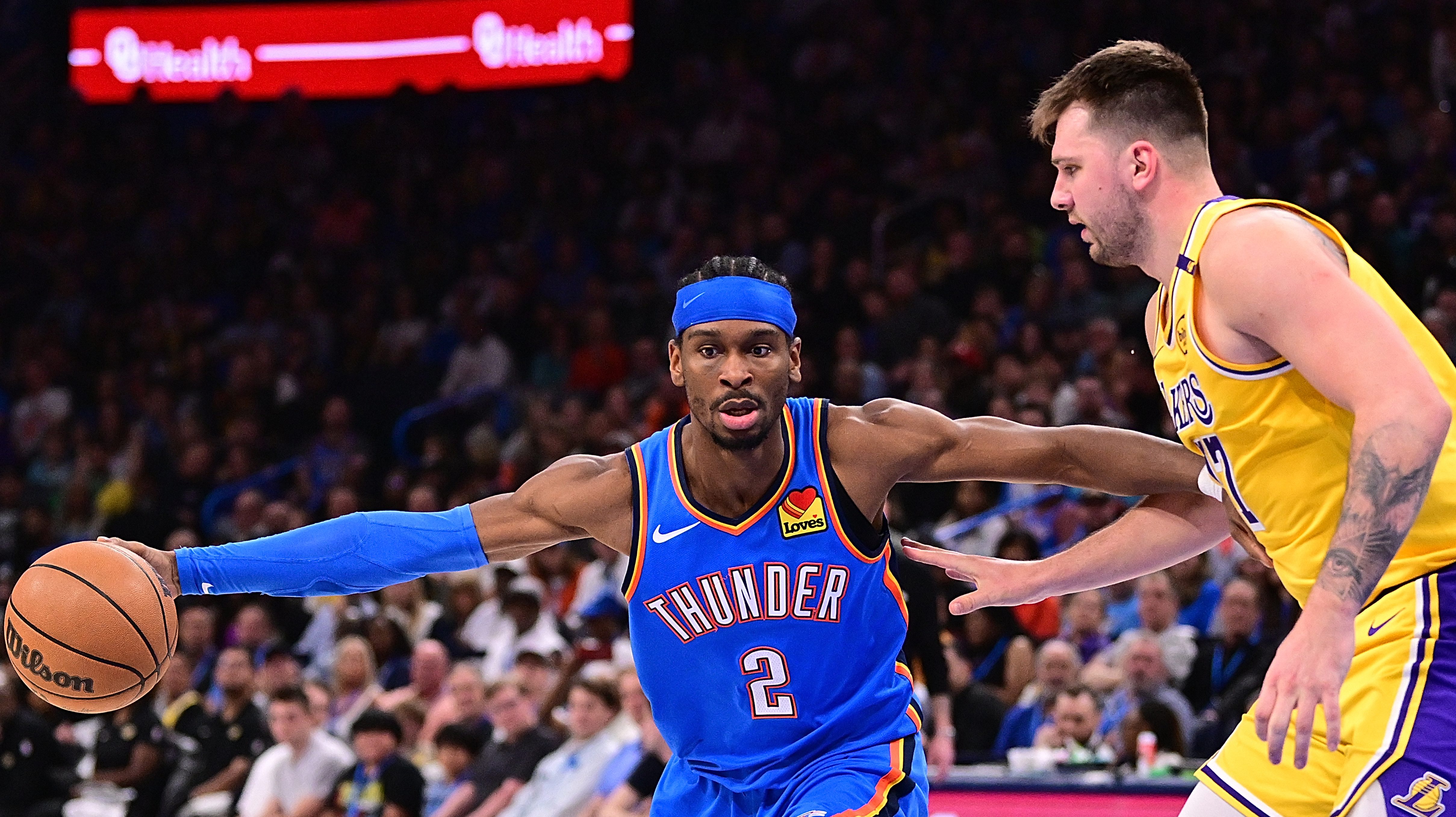 Oklahoma City Thunder guard Shai Gilgeous-Alexander defended by Los Angeles Lakers guard Luka Doncic