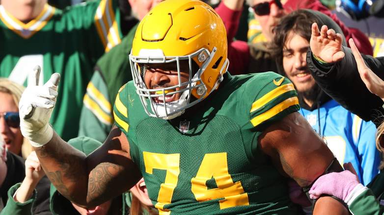 GREEN BAY, WISCONSIN - NOVEMBER 19: Elgton Jenkins #74 of the Green Bay Packers celebrates with fans after Jayden Reed #11 scored a touchdown in the second quarter against the Los Angeles Chargers at Lambeau Field on November 19, 2023 in Green Bay, Wisconsin. (Photo by Stacy Revere/Getty Images)