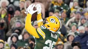 GREEN BAY, WISCONSIN - DECEMBER 07: Keisean Nixon #25 of the Green Bay Packers catches an interception during the fourth quarter against the Chicago Bears at Lambeau Field on December 07, 2025 in Green Bay, Wisconsin. (Photo by John Fisher/Getty Images)