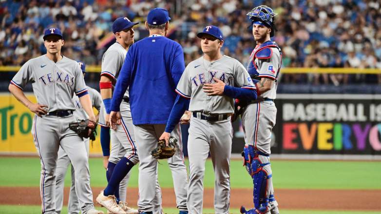Texas Rangers starter Spencer Howard leaves the field after manager Bruce Bochy takes the baseball from him during a pitching change at Tropicana Field.