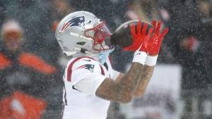 Christian Gonzalez #0 of the New England Patriots intercepts a pass from Jarrett Stidham #8 of the Denver Broncos