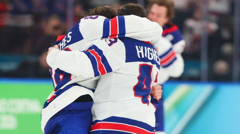 Jack Hughes #86 and Quinn Hughes #43 of Team United States celebrate after a 2-1 victory in overtime against Canada to win the gold medal during the Men's Gold Medal match between Canada and the United States on day 16 of the Milano Cortina 2026 Winter Olympic games at Milano Santagiulia Ice Hockey Arena on February 22, 2026