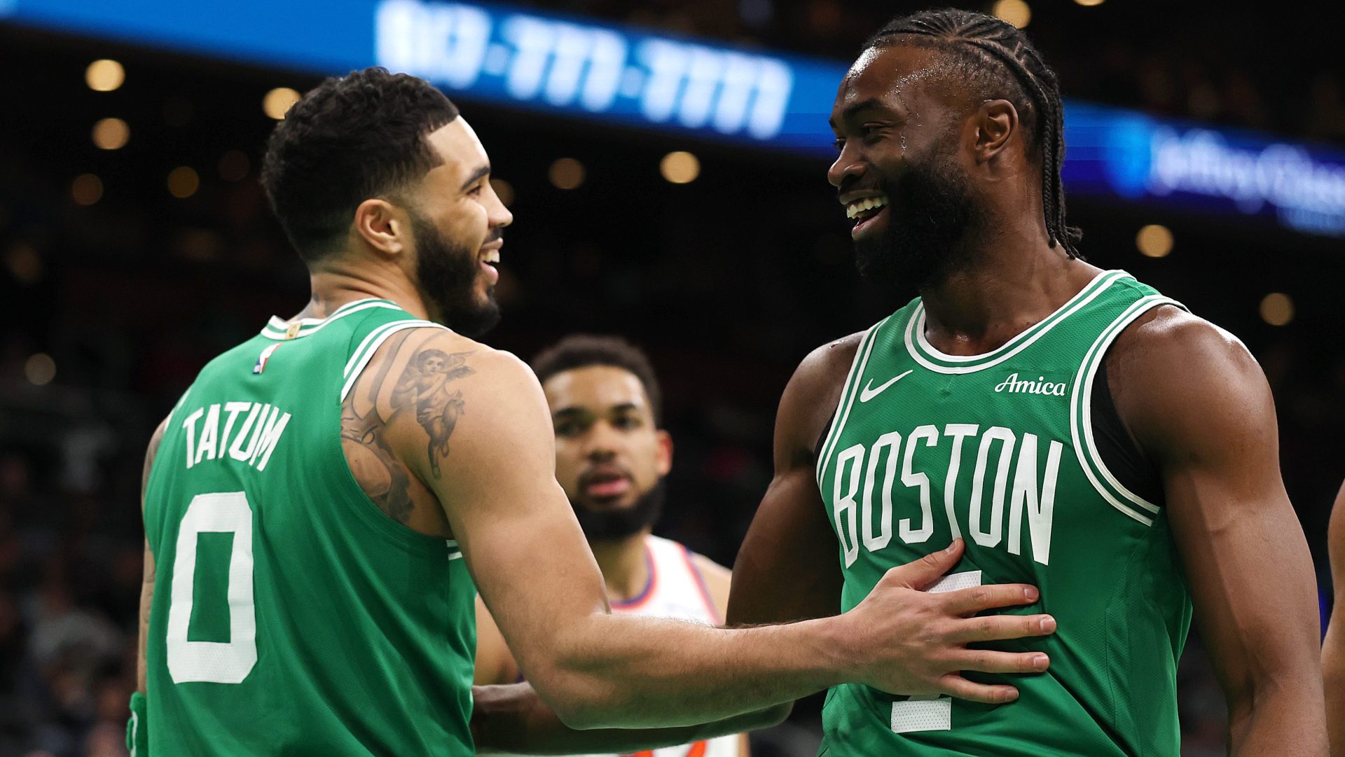 Jayson Tatum of the Boston Celtics and Jaylen Brown laugh together.