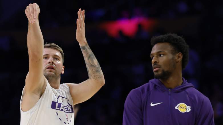 Luka Doncic of the Los Angeles Lakers watches his shot in front of Bronny James.