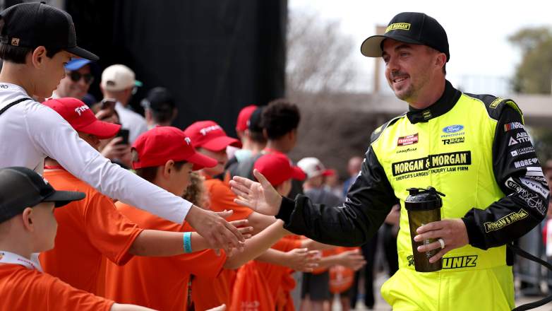 Frankie Muniz high-fiving fans during a NASCAR Truck Series race weekend