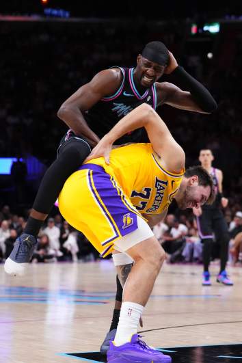 Bam Adebayo of the Miami Heat and Luka Doncic of the Los Angeles Lakers collide