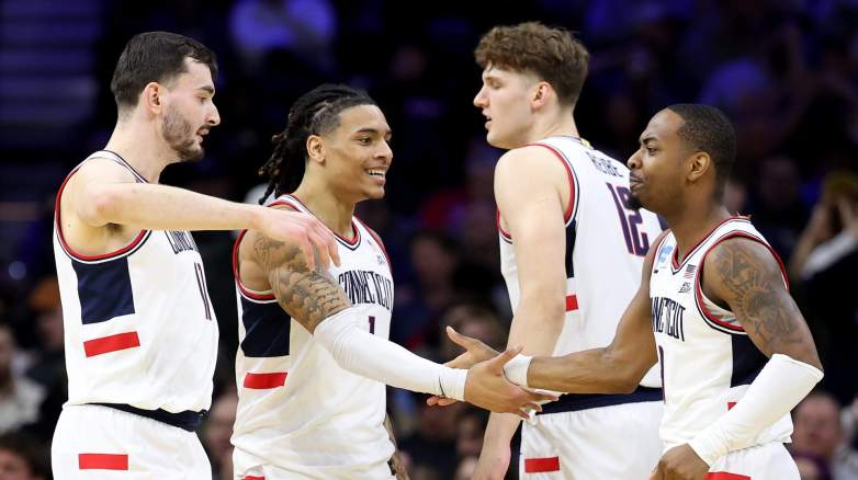 Alec Millender of the UConn Huskies celebrates his basket with Alex Karaban, Solo Ball and Eric Reibe.