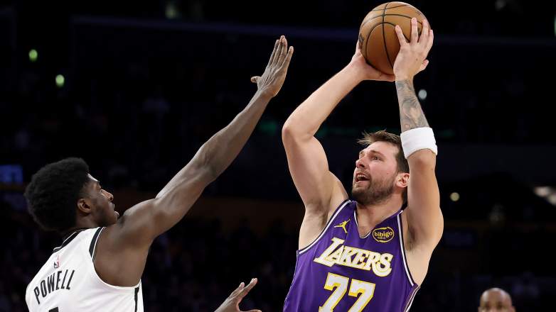 Luka Doncic shoots over defender during Los Angeles Lakers game