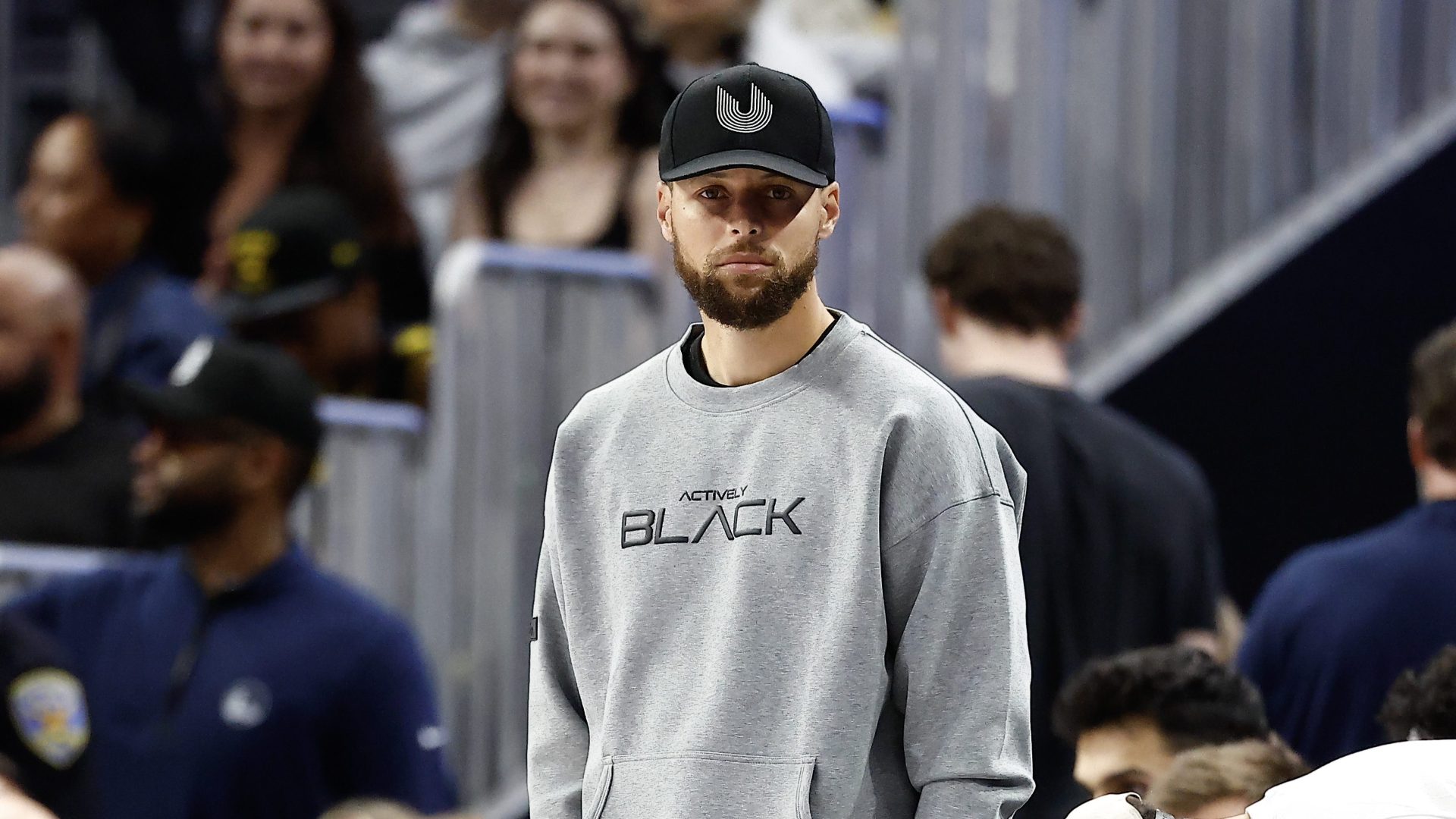 Stephen Curry of the Golden State Warriors stands on the sideline
