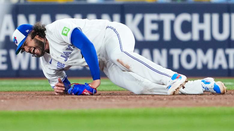 Cody Ponce grimaces in pain with a knee injury.