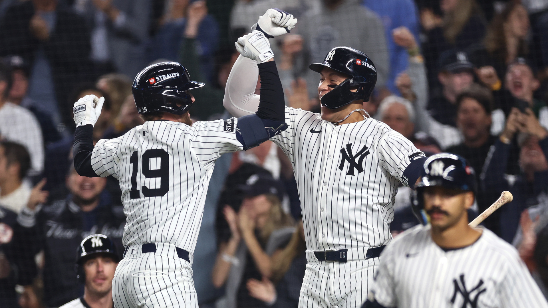 Ryan McMahon #19 of the New York Yankees celebrates with Aaron Judge #99 after hitting a solo home run against the Toronto Blue Jays during the third inning in game four of the American League Division Series at Yankee Stadium on October 08, 2025 in New York City. (Photo by Ishika Samant/Getty Images)
