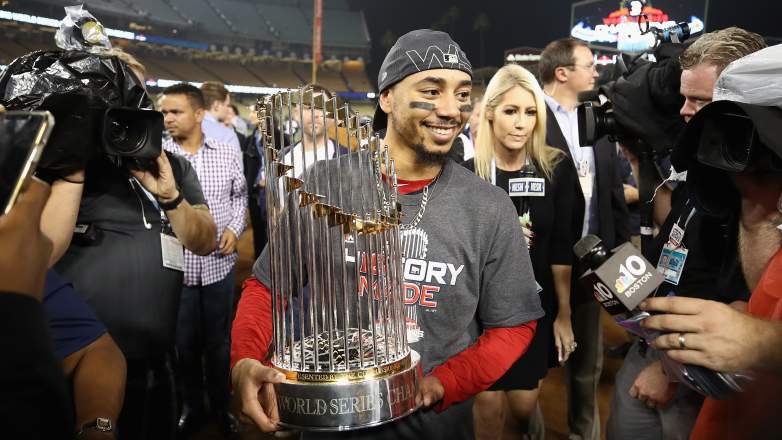 Mookie Betts holds the World Series trophy after the Boston Red Sox defeated the Los Angeles Dodgers in 2018