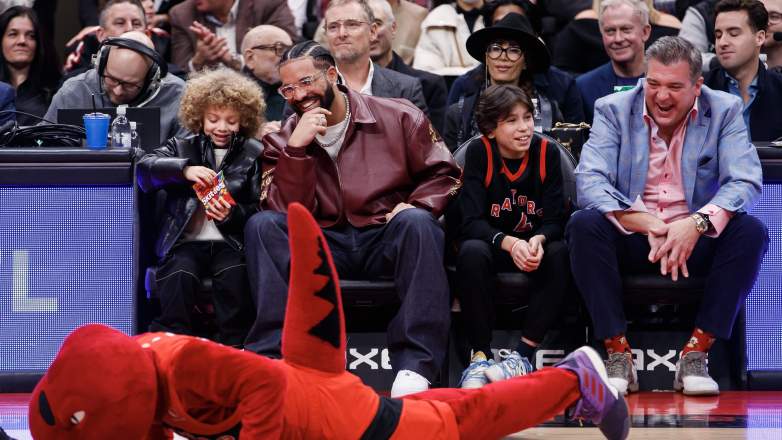 Drake and his son Adonis Graham sitting courtside at a Toronto Raptors game