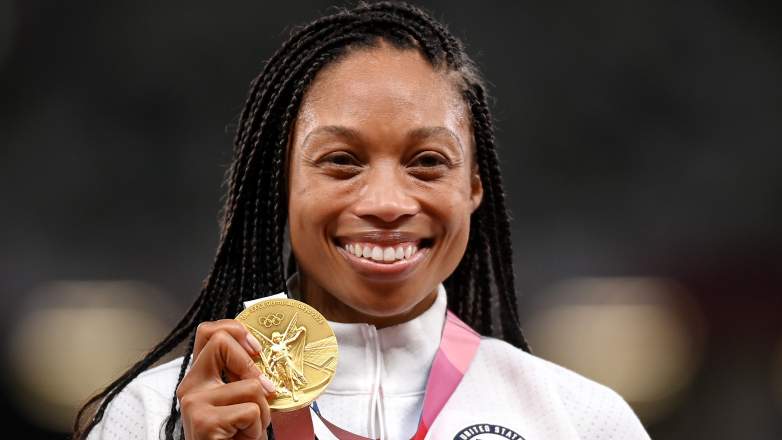 Allyson Felix holding gold medal for Team USA at the Tokyo Olympics 2021