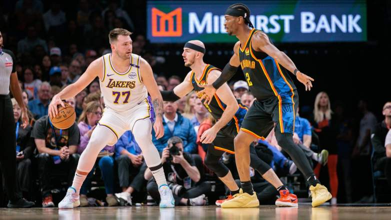 Luka Doncic dribbles against Oklahoma City Thunder defenders during NBA game