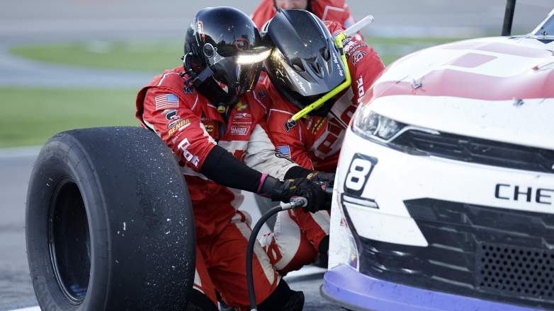NASCAR pit crew changing Goodyear tire during pit stop in Xfinity Series race