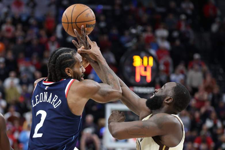 Draymond Green of the Golden State Warriors fouls Kawhi Leonard of the Los Angeles Clippers.